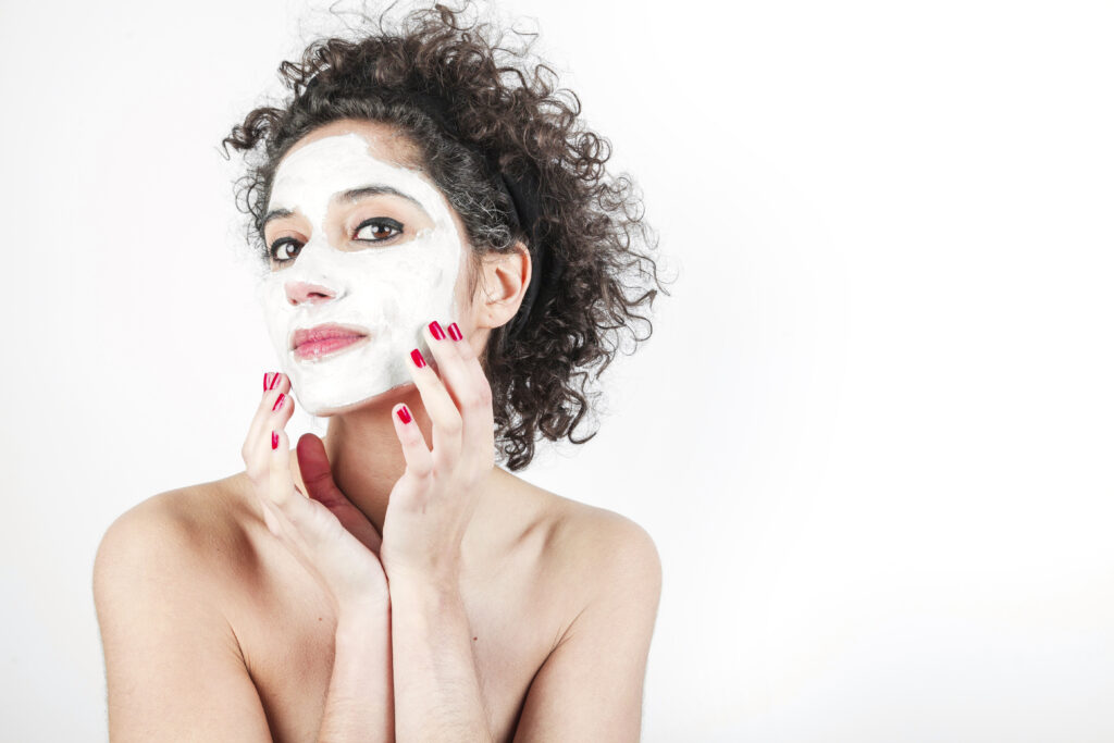 beautiful-young-woman-touching-her-face-mask-isolated-white-background